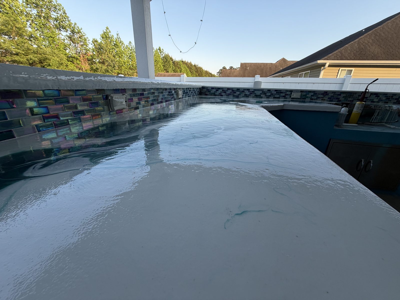 Poolside epoxy bar with glass tile backsplash